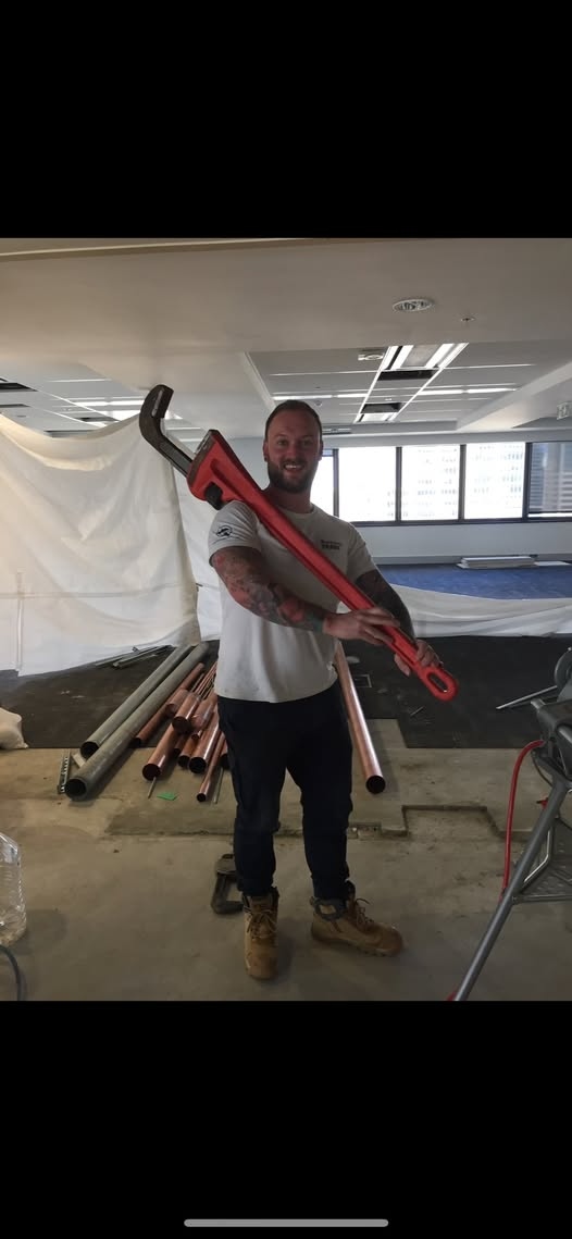 Aaron, owner of Mr. Water Plumbing and Heating, on a commercial job site